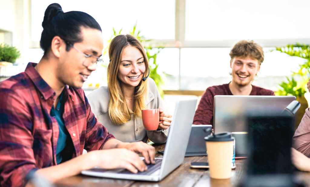 Young employee coworkers sharing content on laptop at startup studio - Human resource business and teamwork concept on office working time - Start up entrepreneurs at coworking space - Bright filter