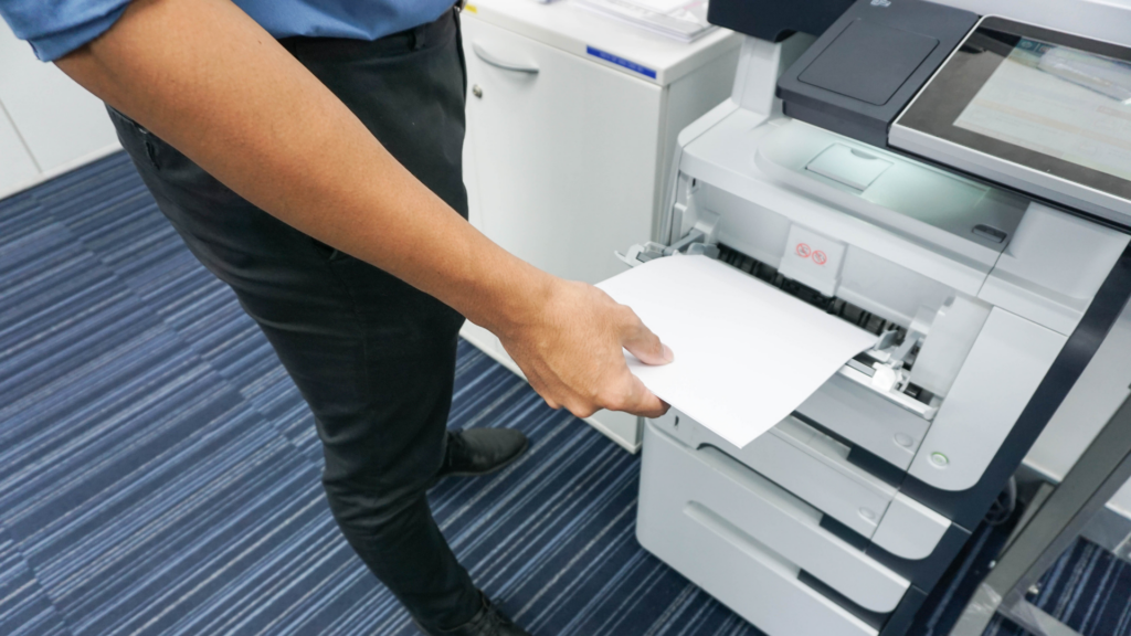 What is Pull Printing – Man collects print job from printer